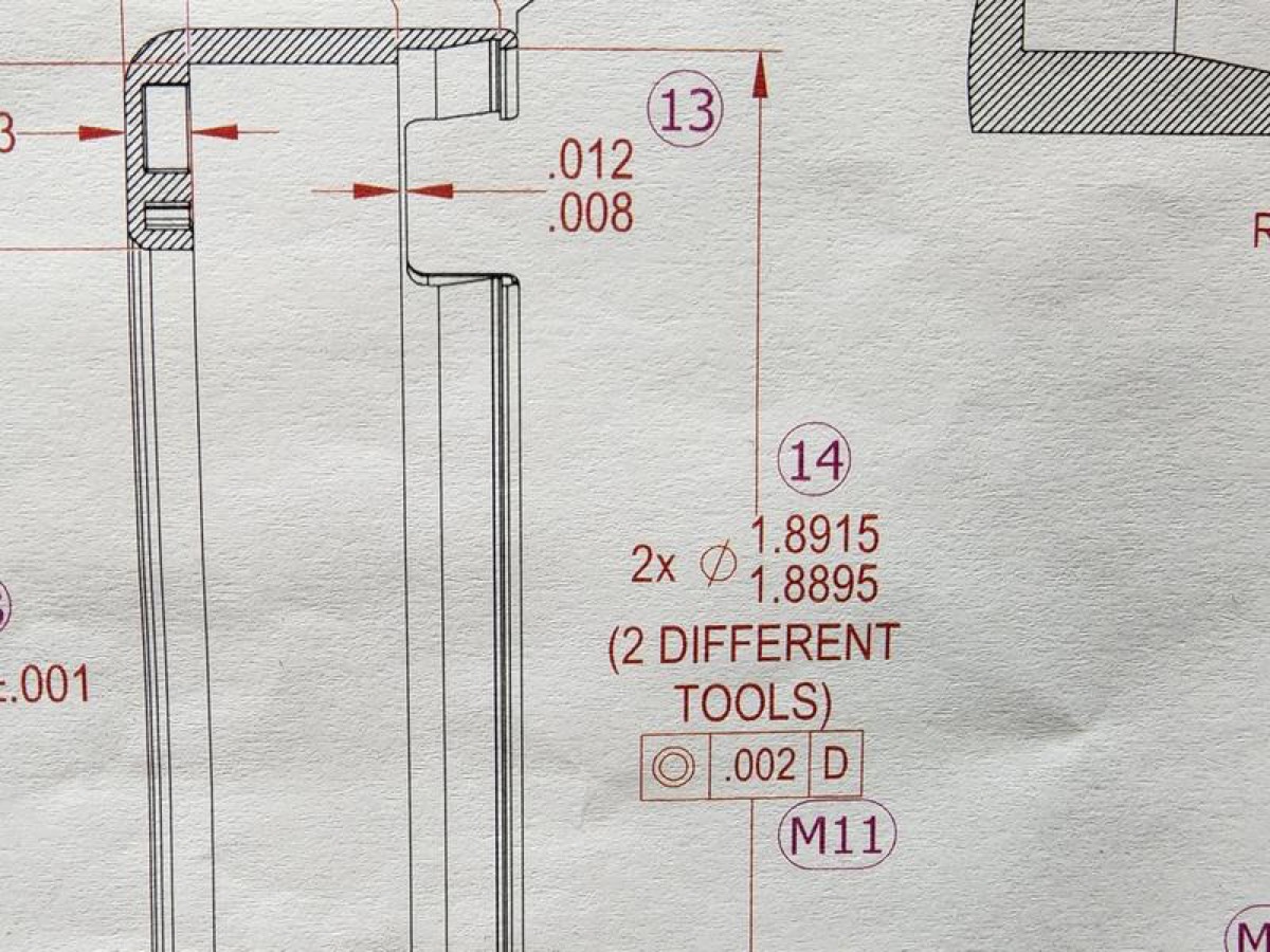 Blueprint cross-section of a machined part with toleranced dimensions and tool callouts.