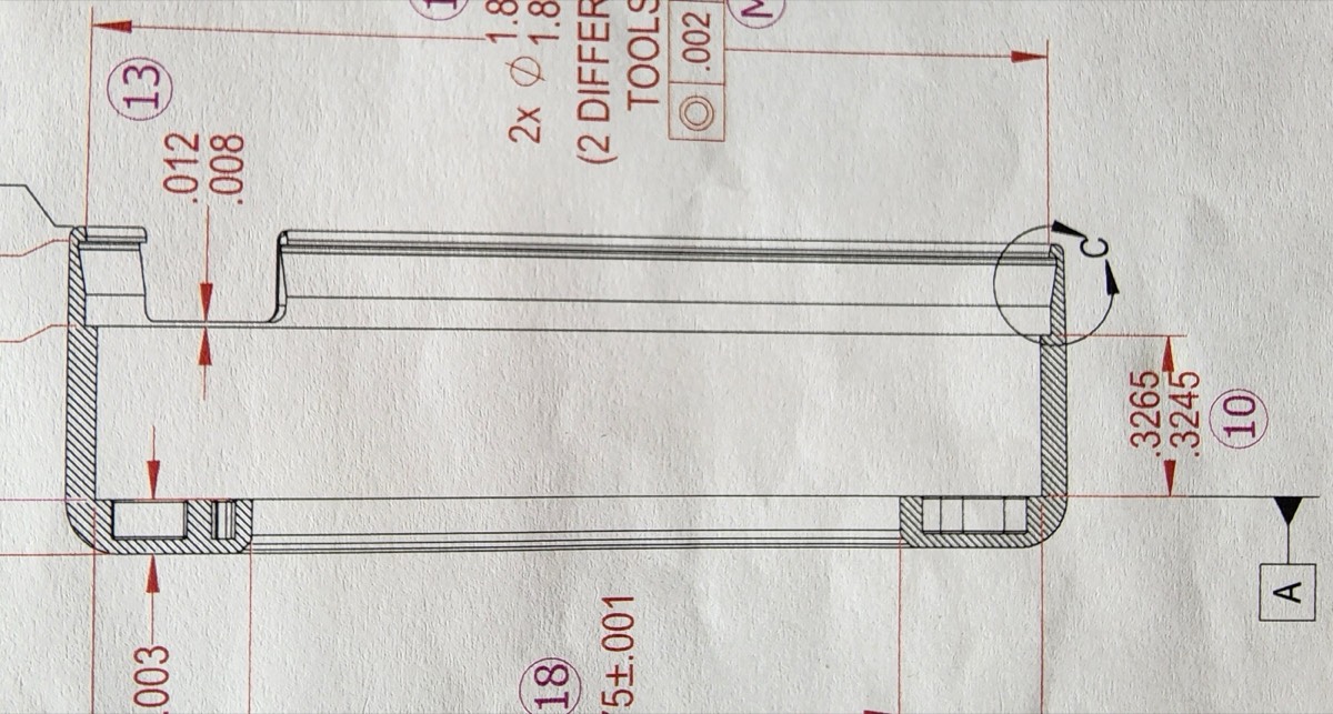 Engineering blueprint showing precision tolerances and cross-section