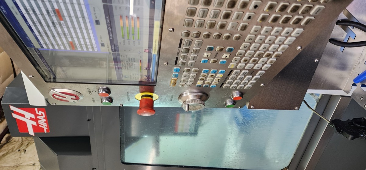 Haas VF-2SS CNC mill control panel with screen and e-stop
