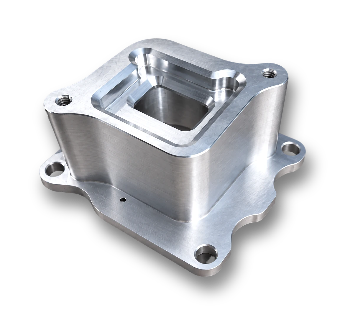 Machined flanged housing with stepped pockets, radiused corners and mounting holes