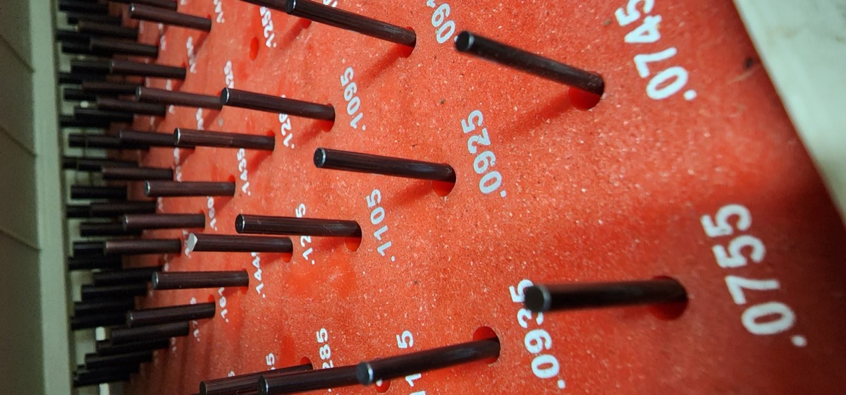 Pin gauge board with labeled sizes for precision measurement